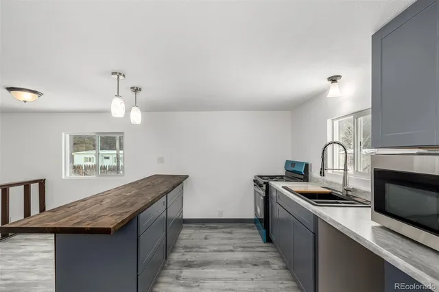 a kitchen with granite countertop a stove and a sink