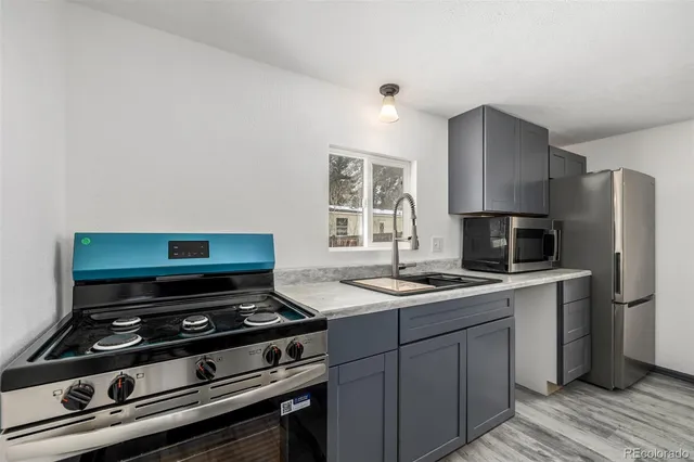 a kitchen with a stove and a refrigerator