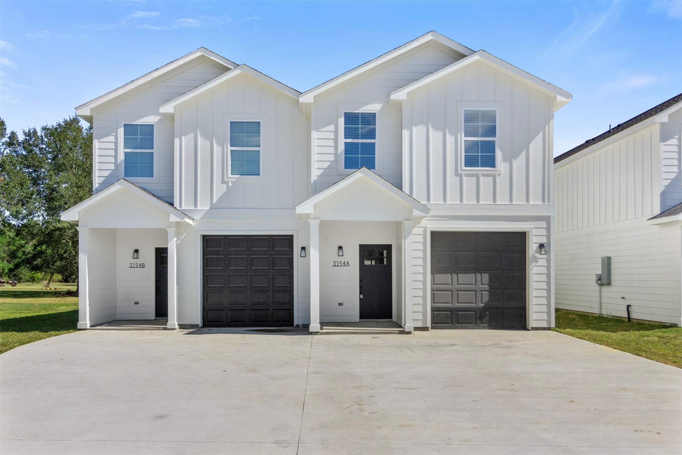 3150 South Cleveland Street Dayton, TX 77535 - Photo 2 of 24 a front view of a house with a yard and garage