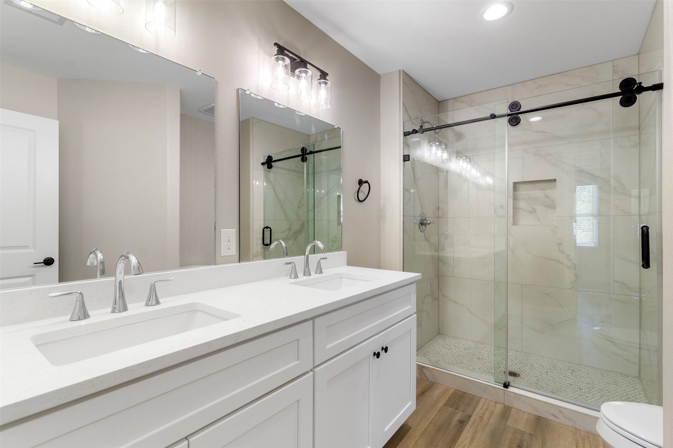 3150 South Cleveland Street Dayton, TX 77535 - Photo 9 of 24 a bathroom with a shower sink vanity mirror and toilet