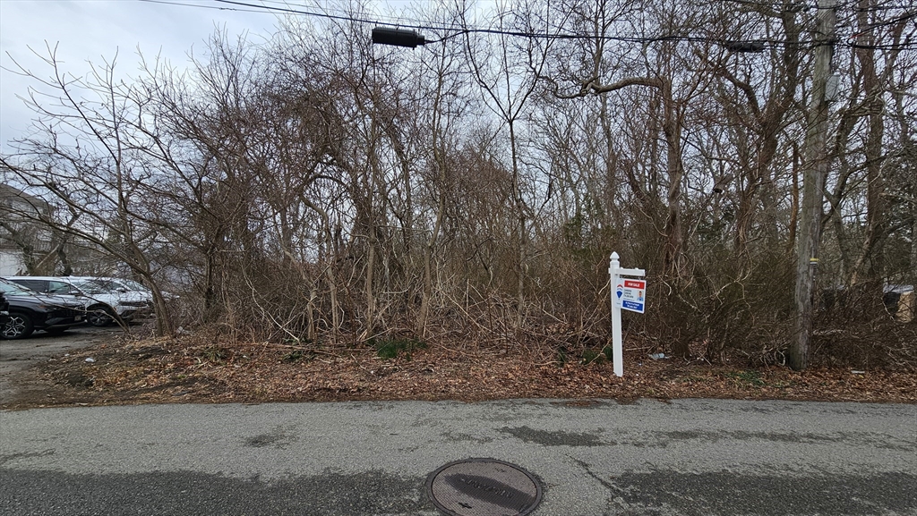 0 Holt Road Bourne, MA 02532 - Photo 3 of 9 a sign that is sitting in the middle of a road