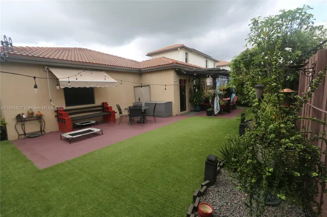 a view of a house with backyard porch and sitting area