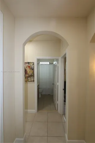 a view of a hallway with wooden shelves