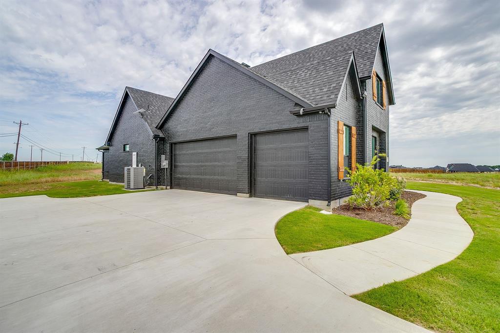 4511 Matador Rnch Road Waxahachie, TX 75165 - Photo 2 of 36 Modern black brick exterior with a multi-car garage
