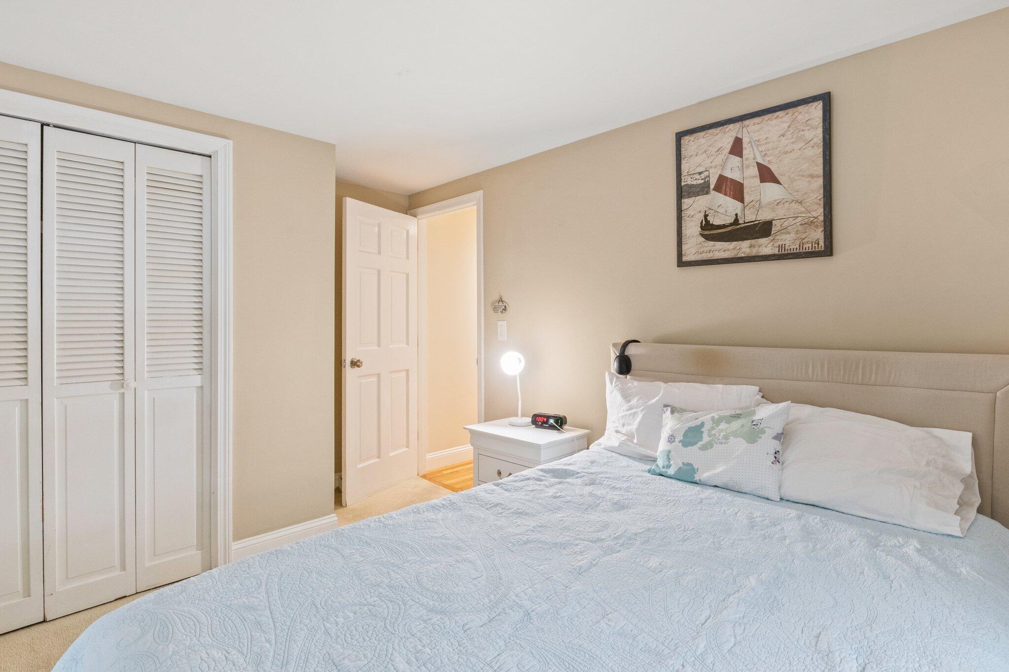 156 Sheaffer Road Centerville, MA 02632 - Photo 23 of 32 a bed room with a bed and a painting
