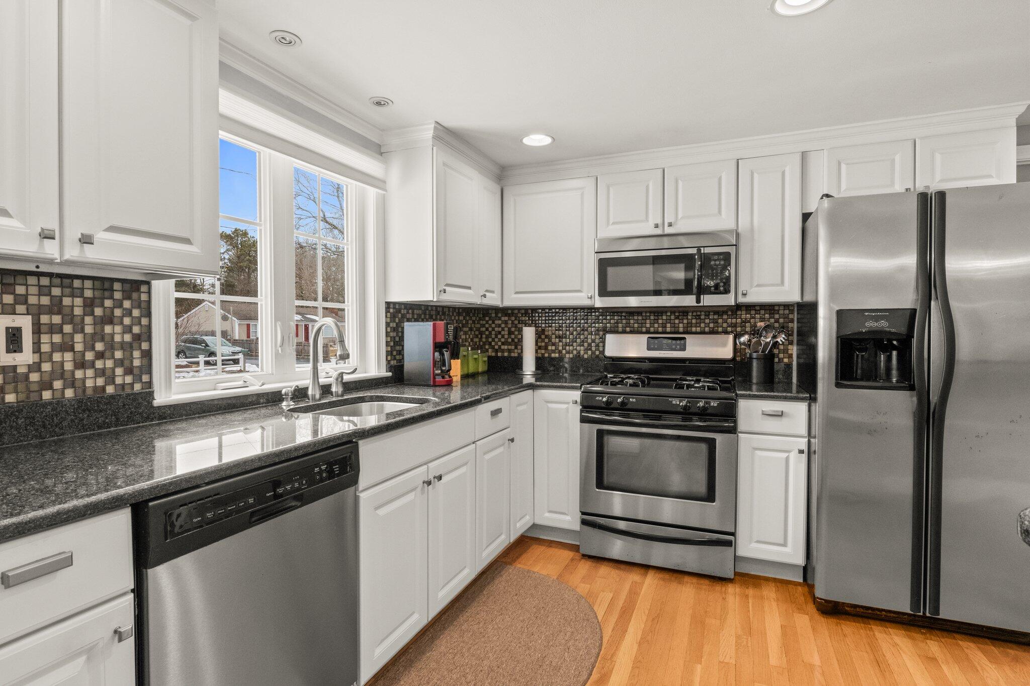 156 Sheaffer Road Centerville, MA 02632 - Photo 3 of 32 a kitchen with stainless steel appliances granite countertop a stove a sink and a refrigerator
