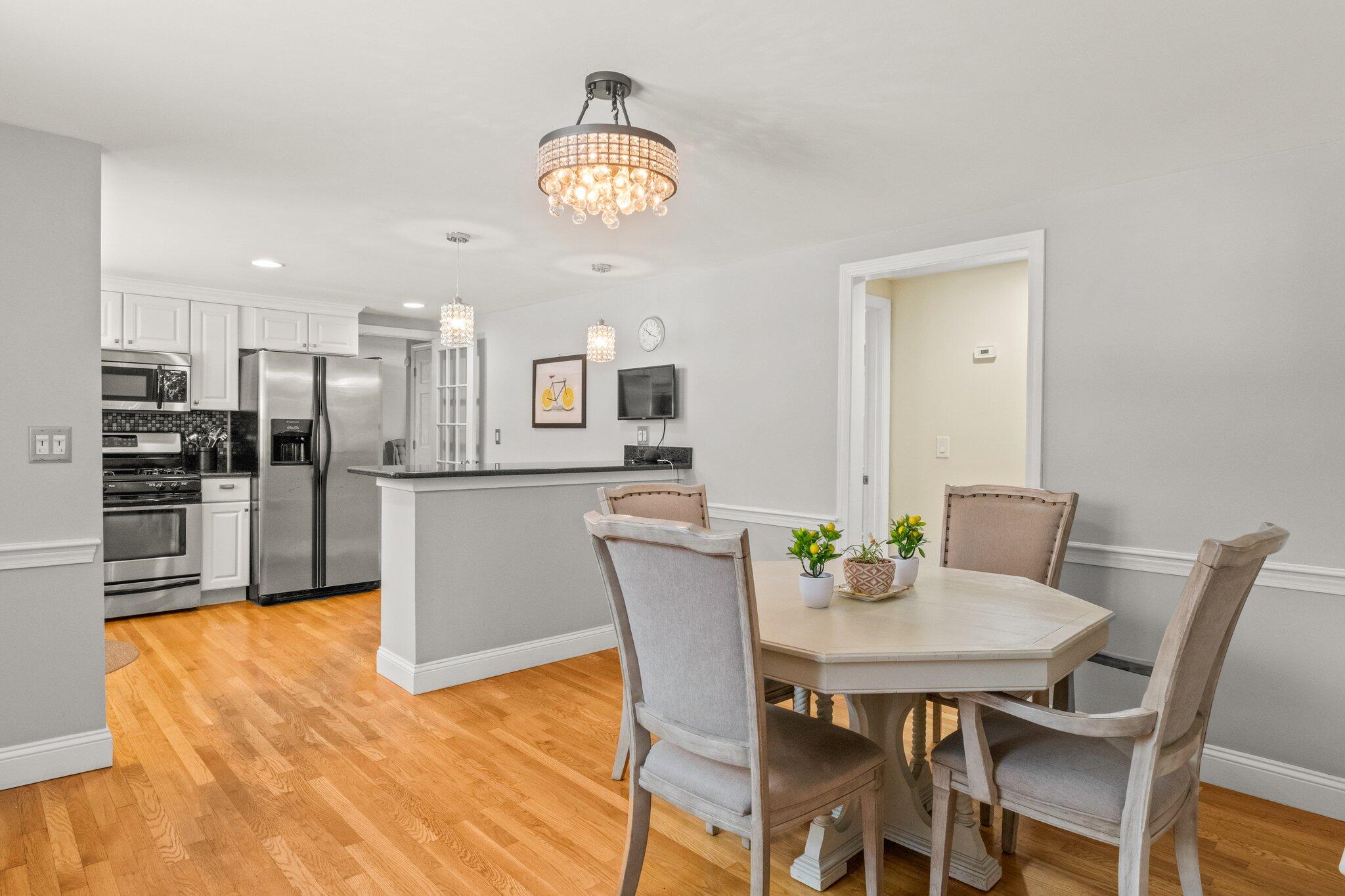 156 Sheaffer Road Centerville, MA 02632 - Photo 8 of 32 a view of a dining room with furniture and wooden floor