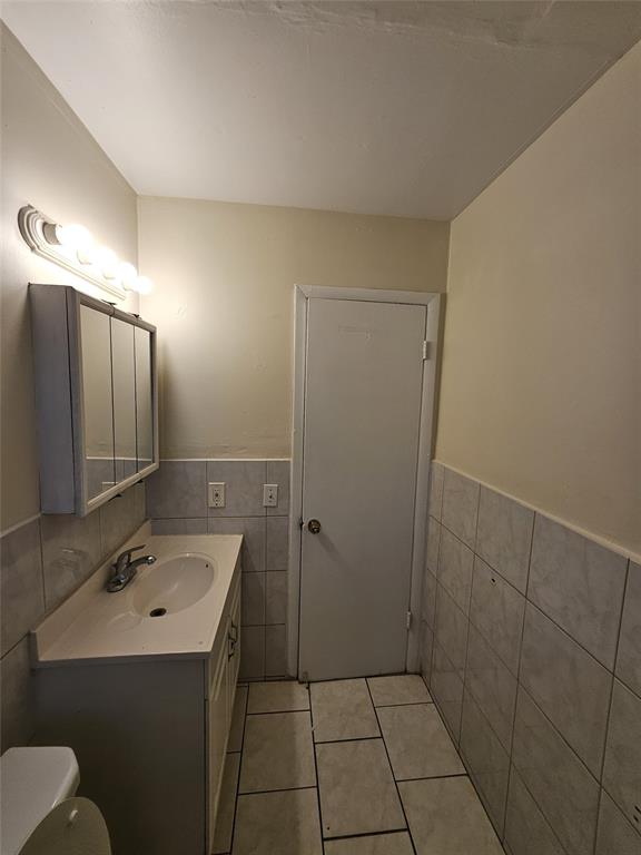 716 Southwest 7th Street, Unit 1 Dania Beach, FL 33004 - Photo 15 of 15 a bathroom with a sink a toilet and mirror