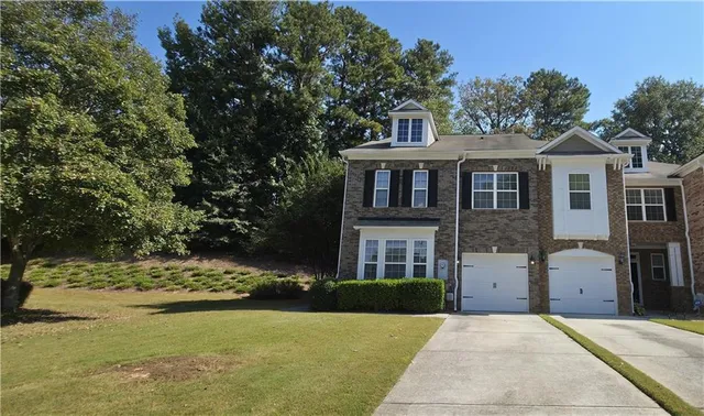 a front view of a house with a yard