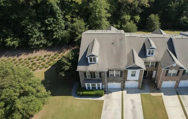 a view of a house with swimming pool next to a yard