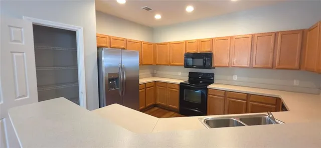 a kitchen with a refrigerator and a sink