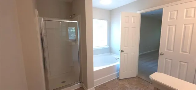 a bathroom with a shower and a toilet