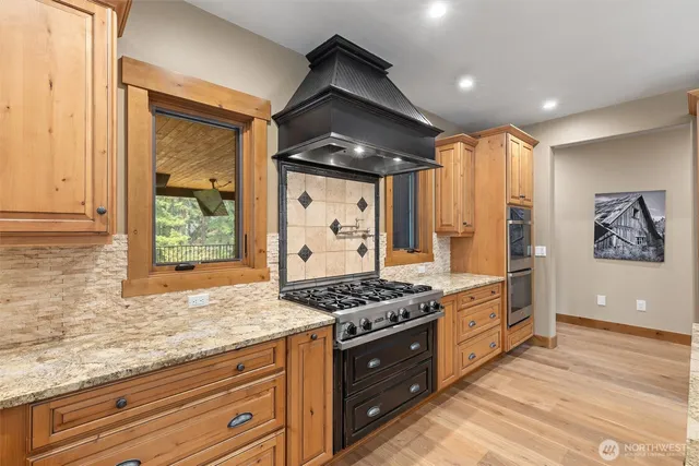 a kitchen with stainless steel appliances granite countertop a stove and a refrigerator