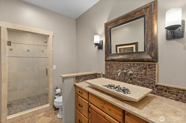 a bathroom with a stove a sink and a mirror
