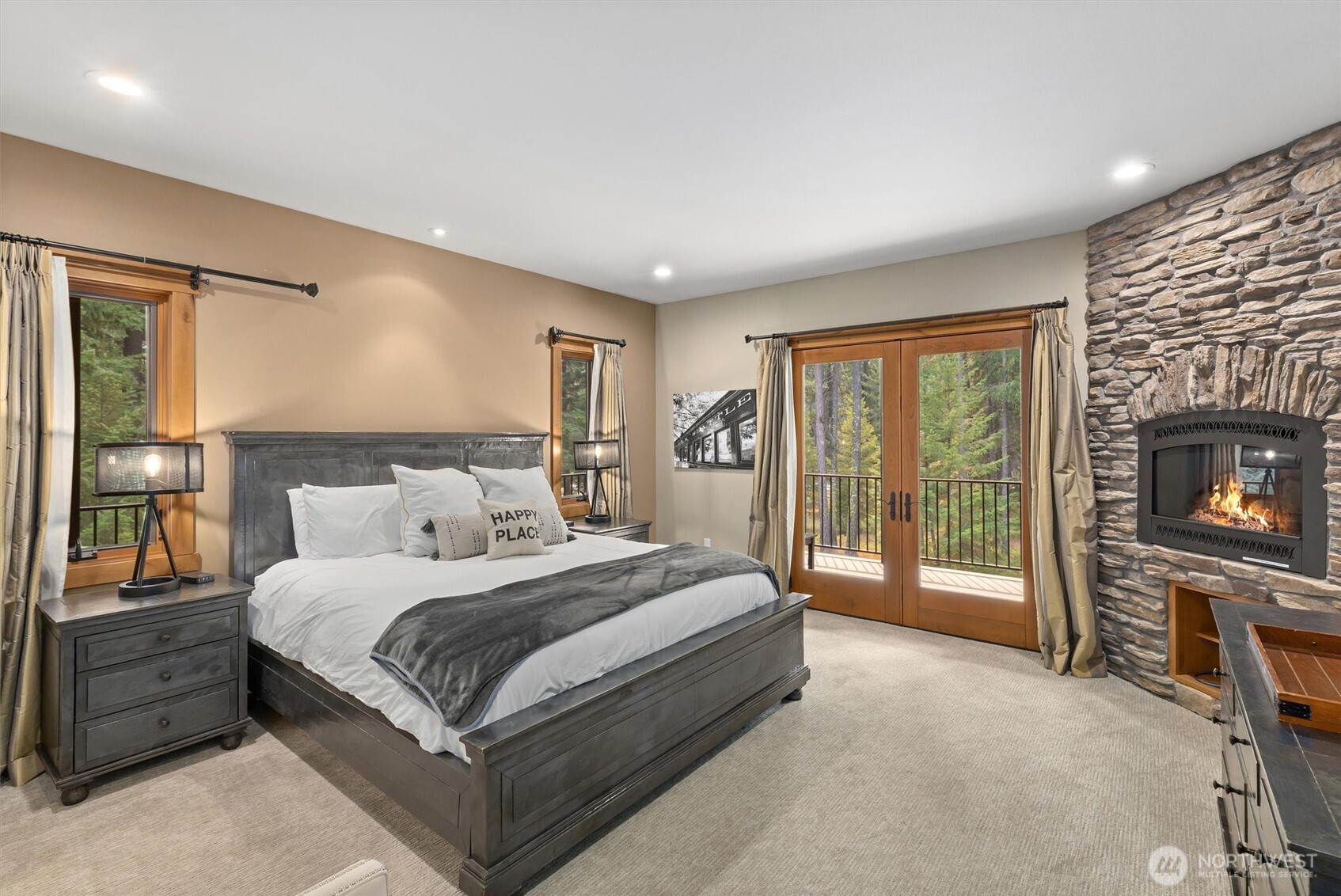 251 Evergreen Valley Loop Road Ronald, WA 98940 - Photo 19 of 40 a spacious bedroom with a bed and a fireplace