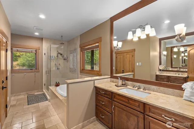 a bathroom with a double vanity sink and a mirror