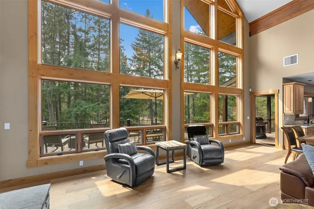 a living room with furniture and floor to ceiling windows