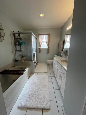 a bathroom with a sink a toilet and shower curtain