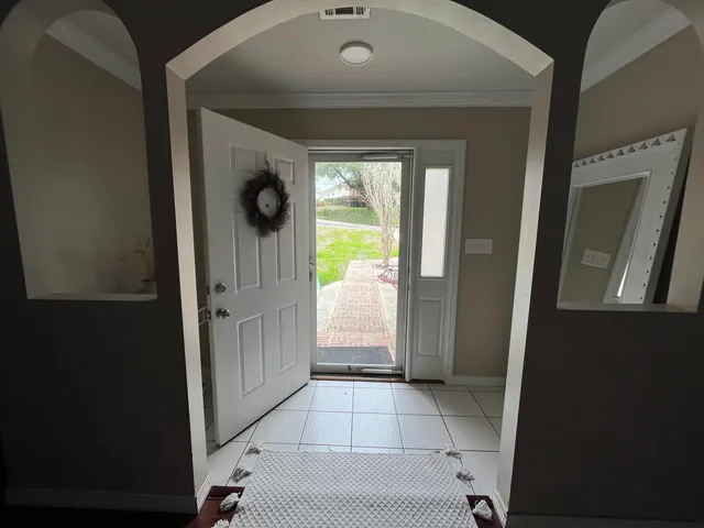 a living room with furniture ceiling fan and a flat screen tv