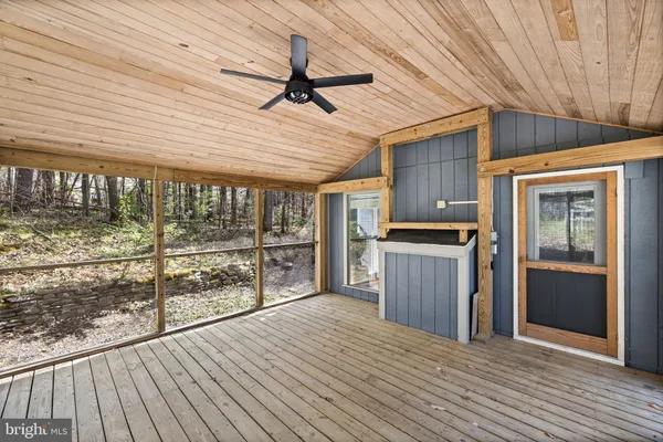 a view of a porch with wooden floor