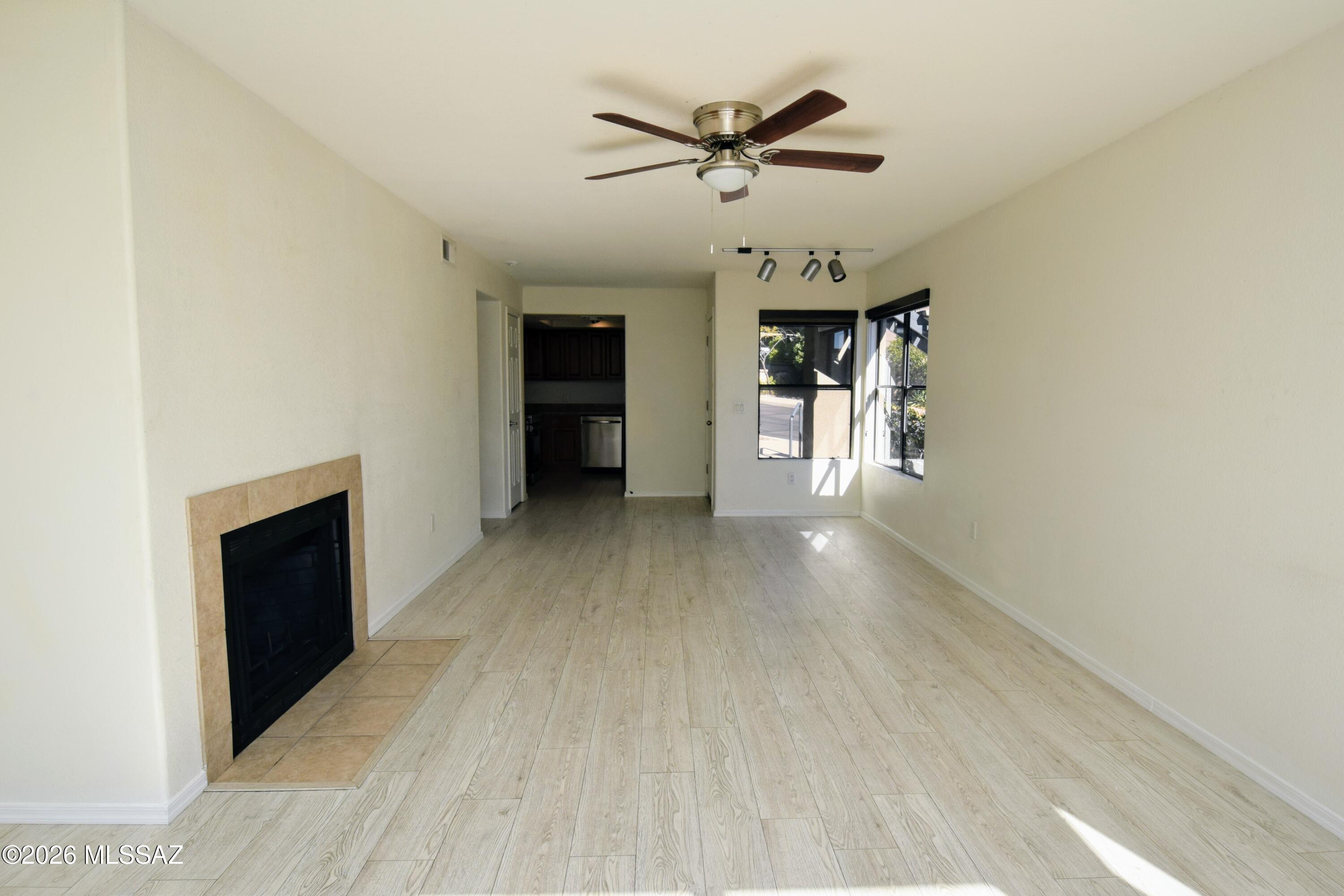 5855 North Kolb Road, Unit 11106 Tucson, AZ 85750 - Photo 8 of 36 a view of a livingroom with a hardwood floor and a ceiling fan