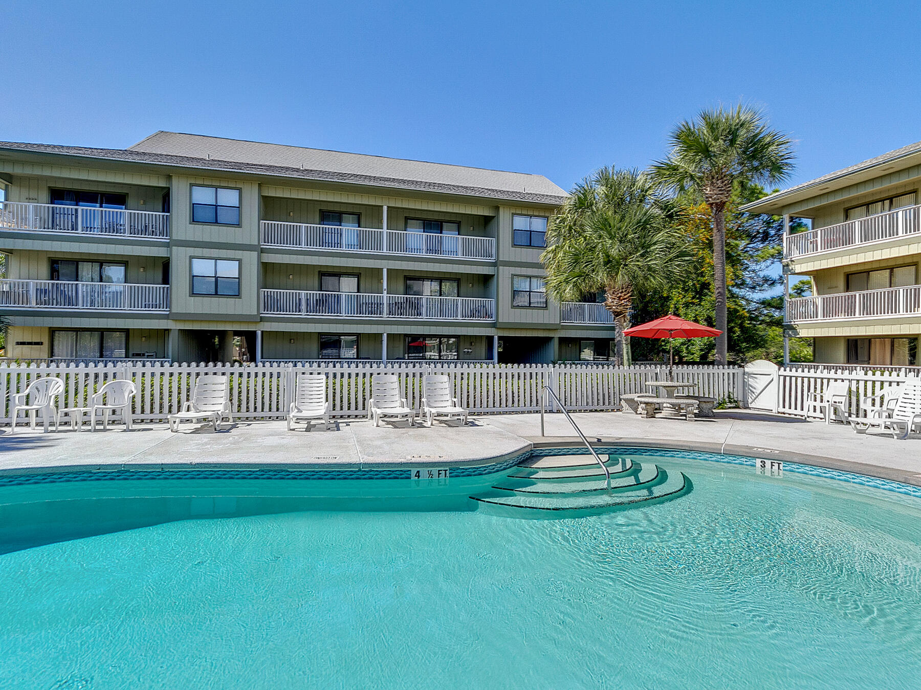 3799 East County Highway 30A, Unit D5 Santa Rosa Beach, FL 32459 - Photo 12 of 34 a front view of a house with a yard table and chairs