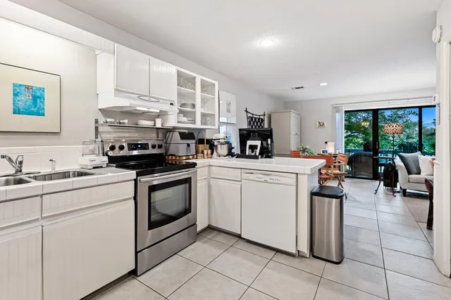 a kitchen with stainless steel appliances granite countertop a stove sink and cabinets