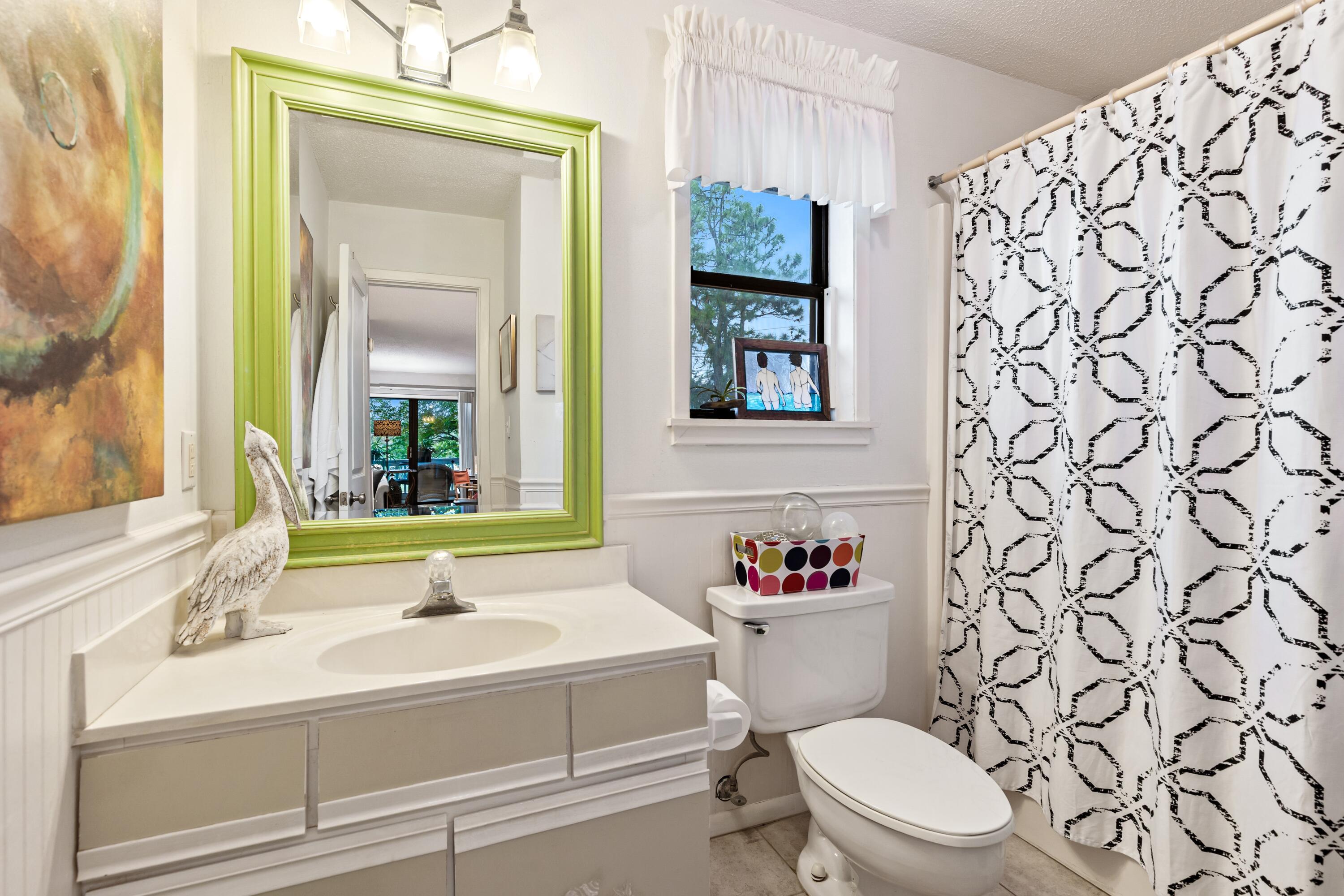 3799 East County Highway 30A, Unit D5 Santa Rosa Beach, FL 32459 - Photo 8 of 34 a bathroom with a sink a toilet and a mirror