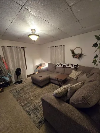 a living room with furniture and a ceiling fan