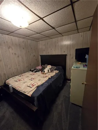 a bed sitting in a bedroom next to a larger window