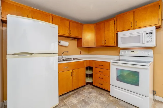 a kitchen with stainless steel appliances granite countertop cabinets and a refrigerator
