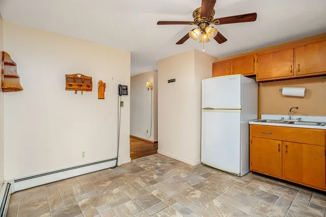 a view of a kitchen with a sink and a refrigerator
