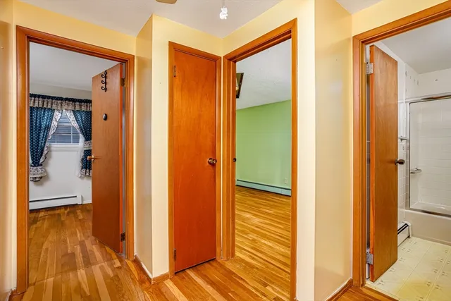 a view of a hallway with wooden floor