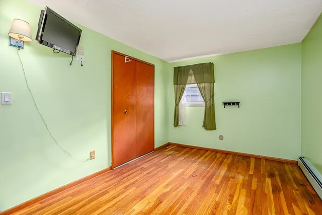 a view of a room with wooden floor and bathroom