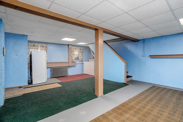 a view of a hallway with an empty room and wooden floor