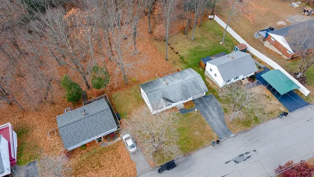 an aerial view of a house with a yard