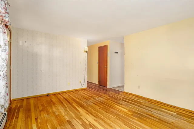 a view of a room with wooden floor