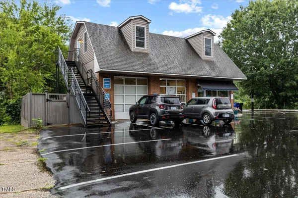 a front view of a house with parking space