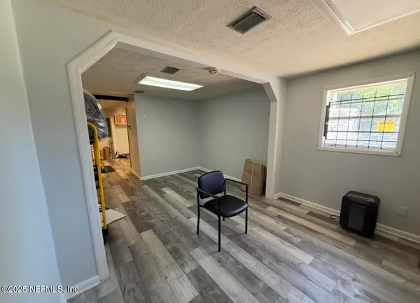 a view of a workspace with furniture and a window