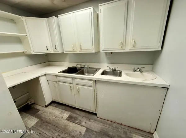 a kitchen with white cabinets and white appliances