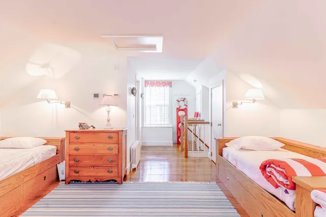 a view of a big room with wooden floor and windows
