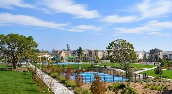 a swimming pool with outdoor seating and lake
