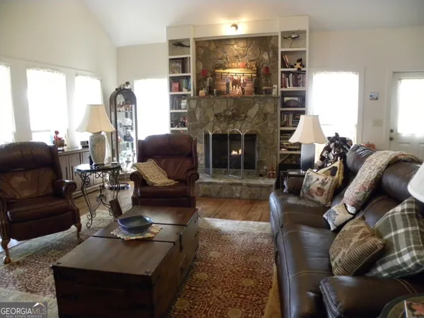 a kitchen with stainless steel appliances granite countertop a table chairs refrigerator and a sink