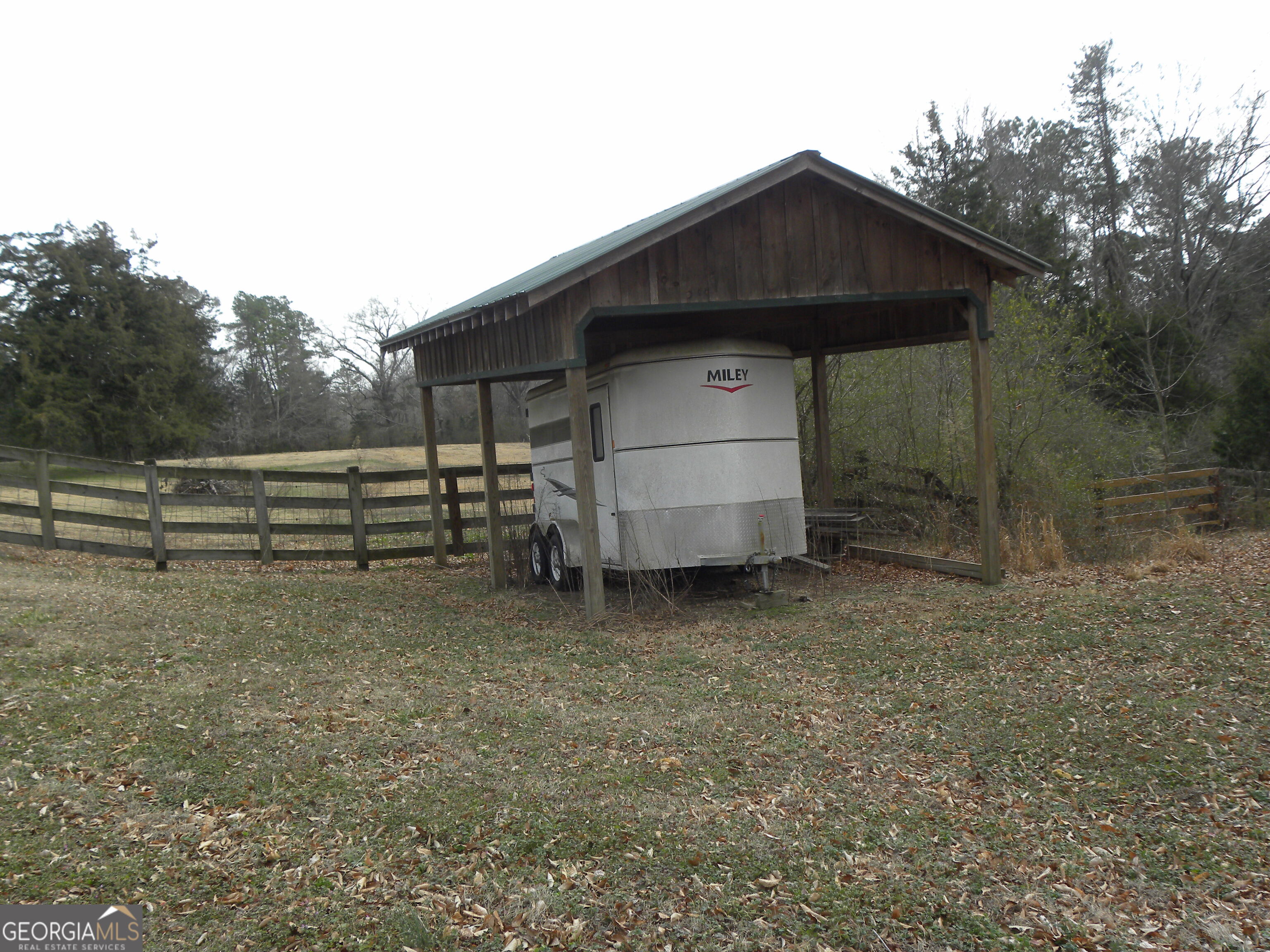 551 P Road Toccoa, GA 30577 - Photo 123 of 124 a small barn with a table and chairs under an umbrella