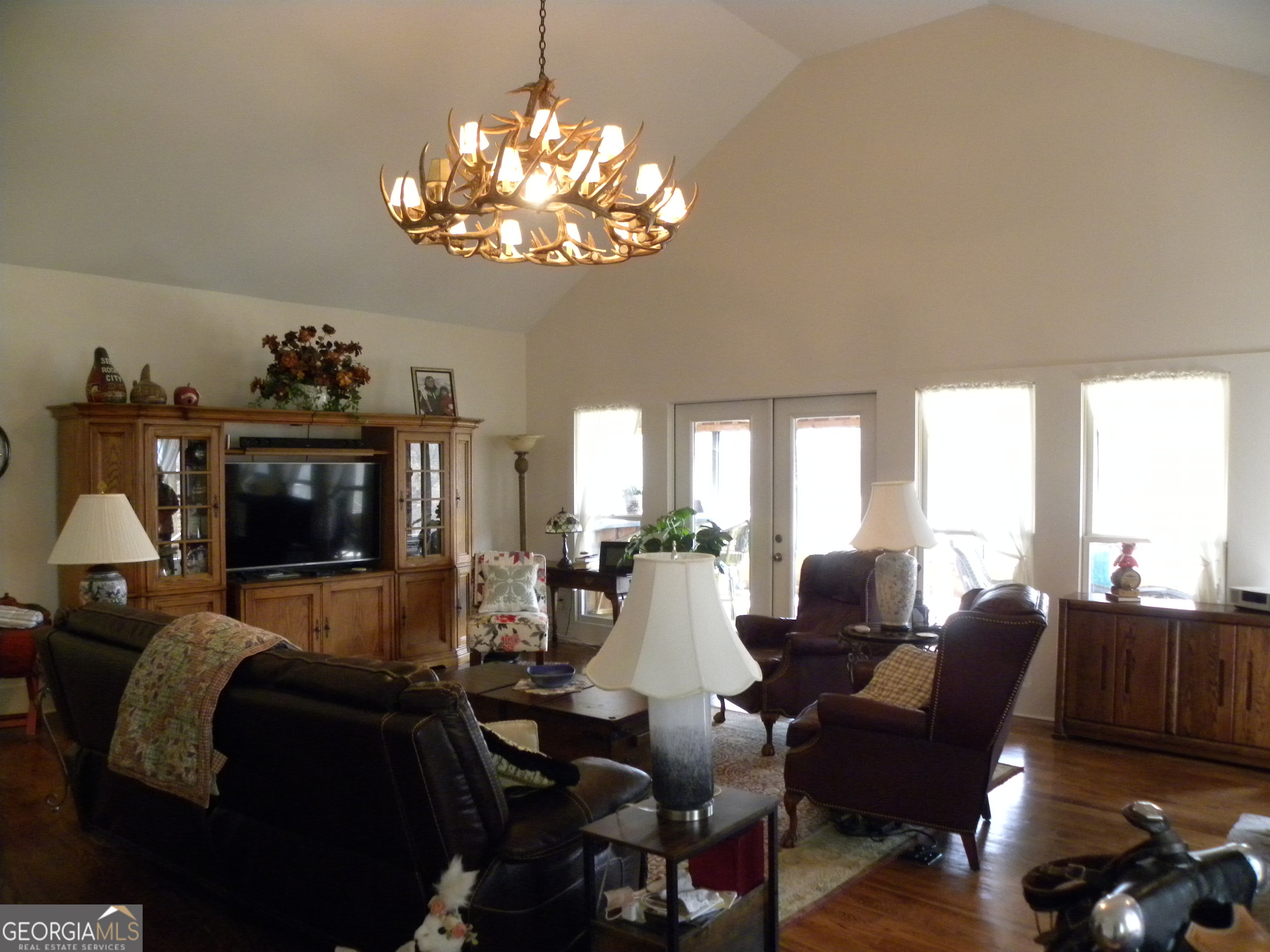 551 P Road Toccoa, GA 30577 - Photo 17 of 124 a living room with furniture a chandelier and a flat screen tv
