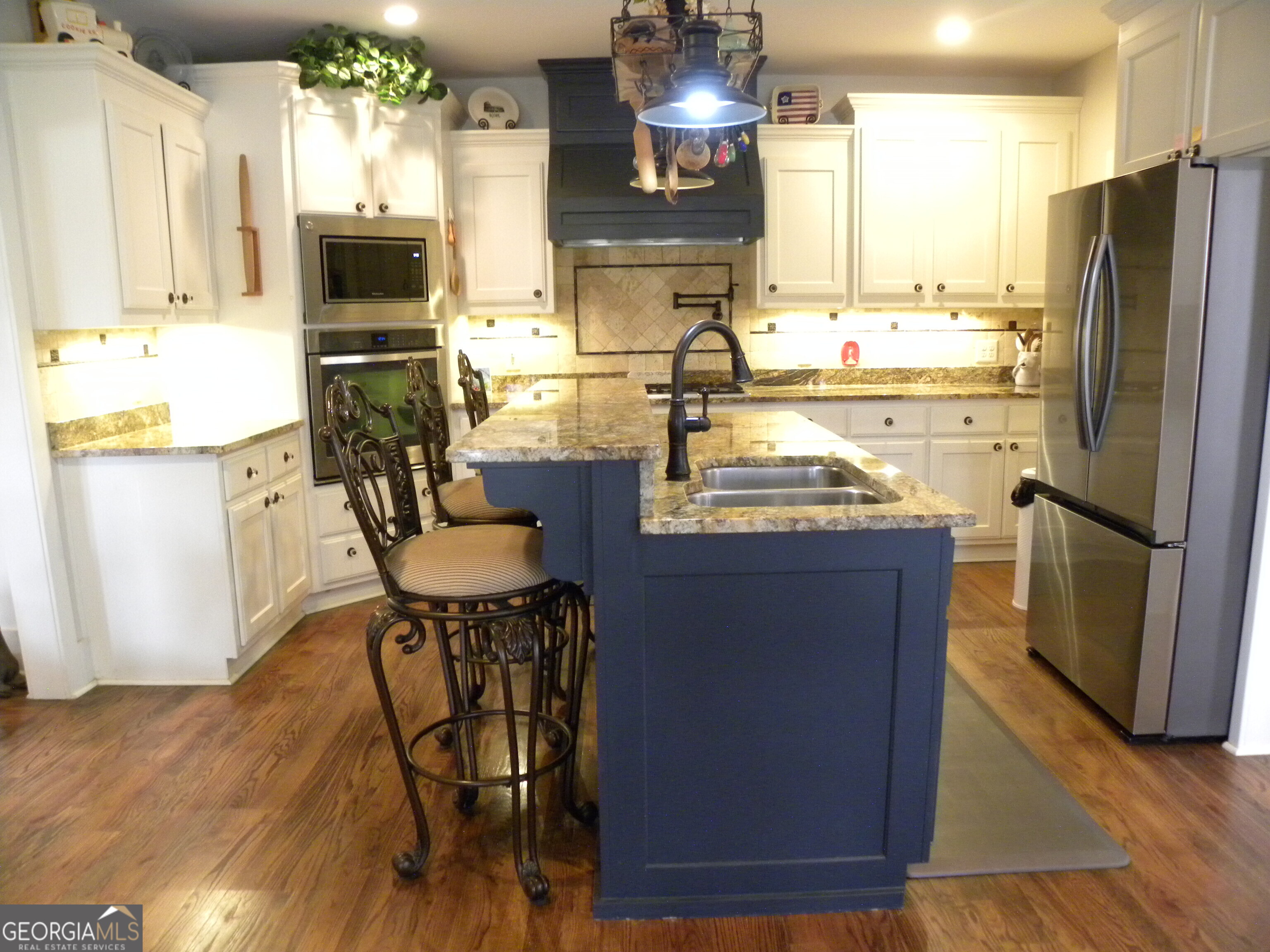 551 P Road Toccoa, GA 30577 - Photo 24 of 124 a kitchen with stainless steel appliances granite countertop a table chairs refrigerator and a sink