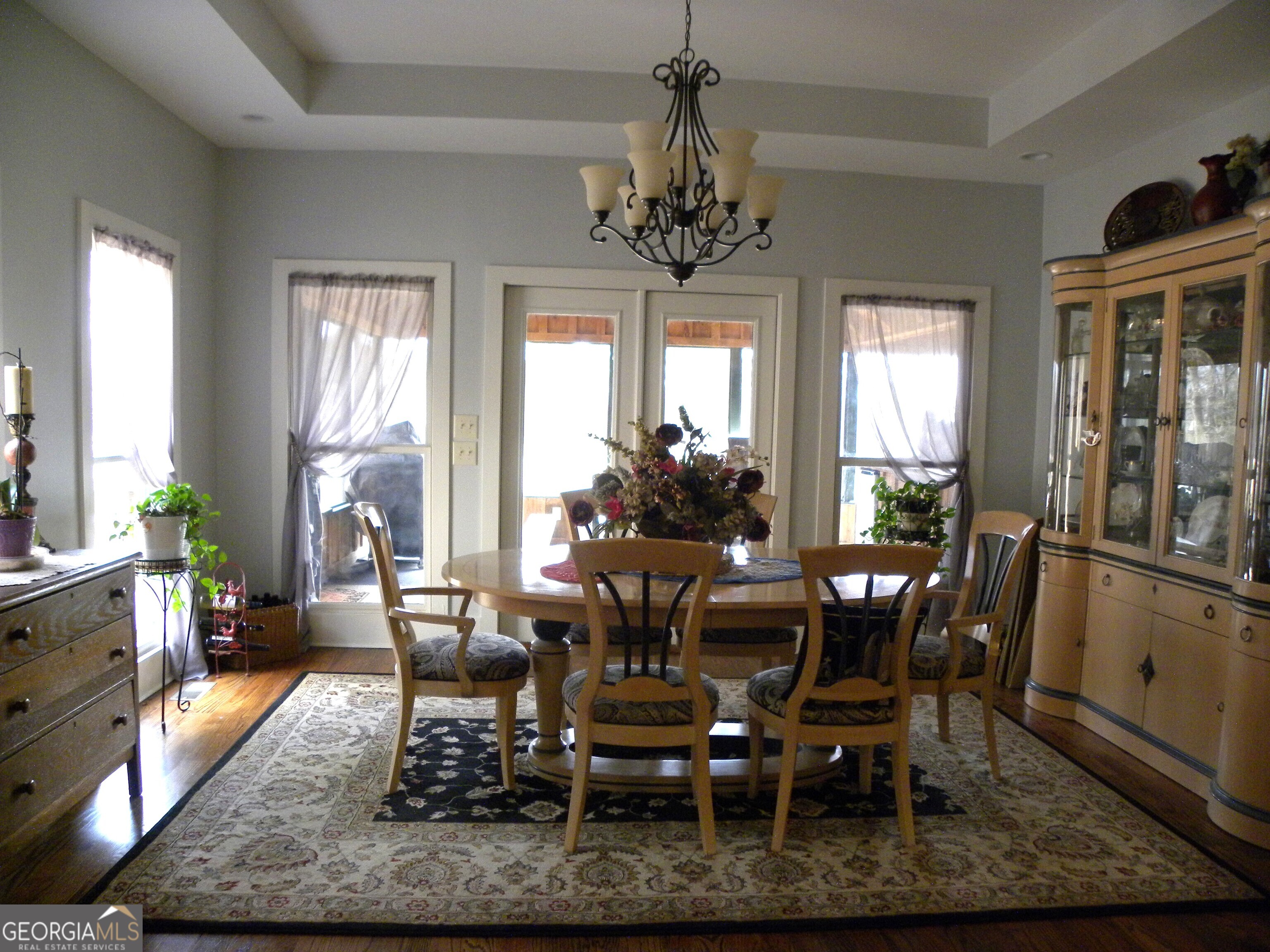 551 P Road Toccoa, GA 30577 - Photo 27 of 124 a dining room with wooden floor a chandelier a wooden table and chairs