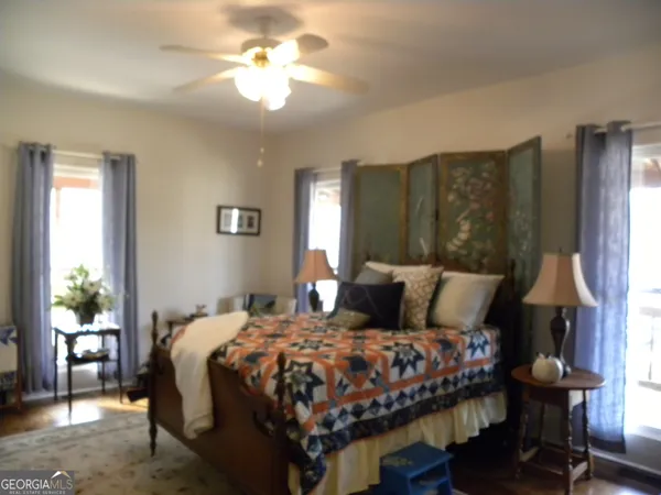 a dining room with furniture and a floor to ceiling window