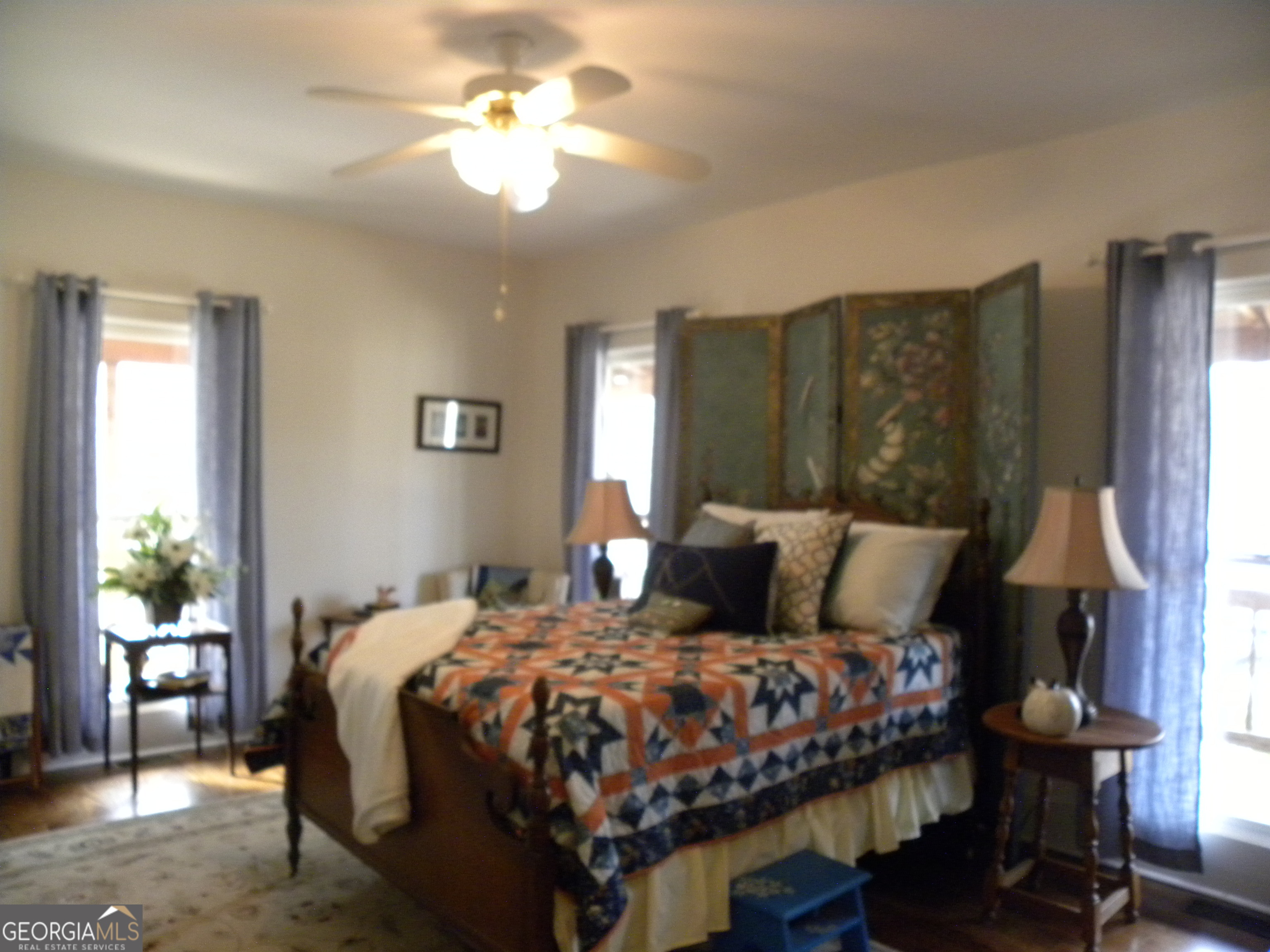 551 P Road Toccoa, GA 30577 - Photo 30 of 124 a bedroom with a bed a chandelier and a window