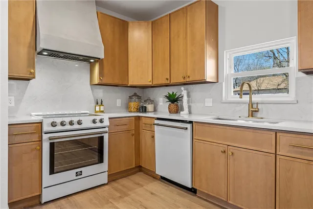 a kitchen with cabinets appliances and a sink